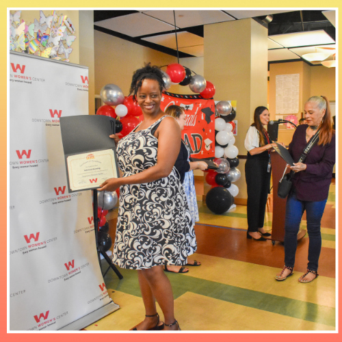 one of the August 2024 LA:RISE cohort graduates gets her photo taken as she shows off her completion certificate