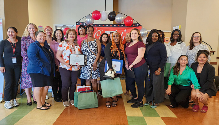 the August 2024 LA:RISE cohort graduates as a group with their certificates of completion