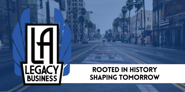 L.A. Legacy Business logo (the program name in white art deco font flanked by art deco style blue wings) over a monotone blue image of Hollywood Boulevard at the intersection of Hollywood Boulevard and Highland Avenue, with the words Rooted in History, Shaping Tomorrow