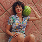 founder of Sno con Amor Lauda Flores with a watermelon, one of the many natural ingredients she uses to create her artisanal Mexican paletas and snow cones